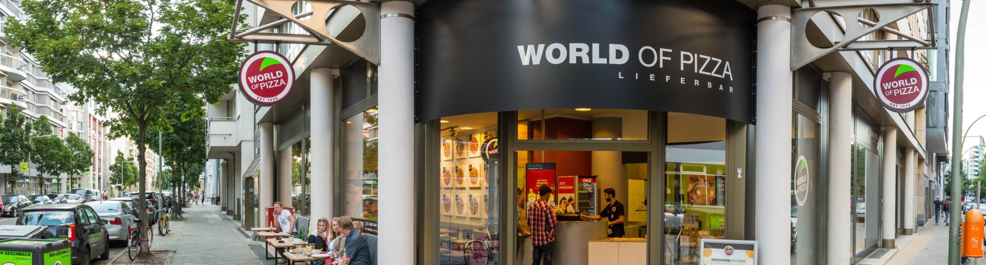 Ein Bild eines Ladens mit einem Schild mit der Aufschrift „Weltpizza“.